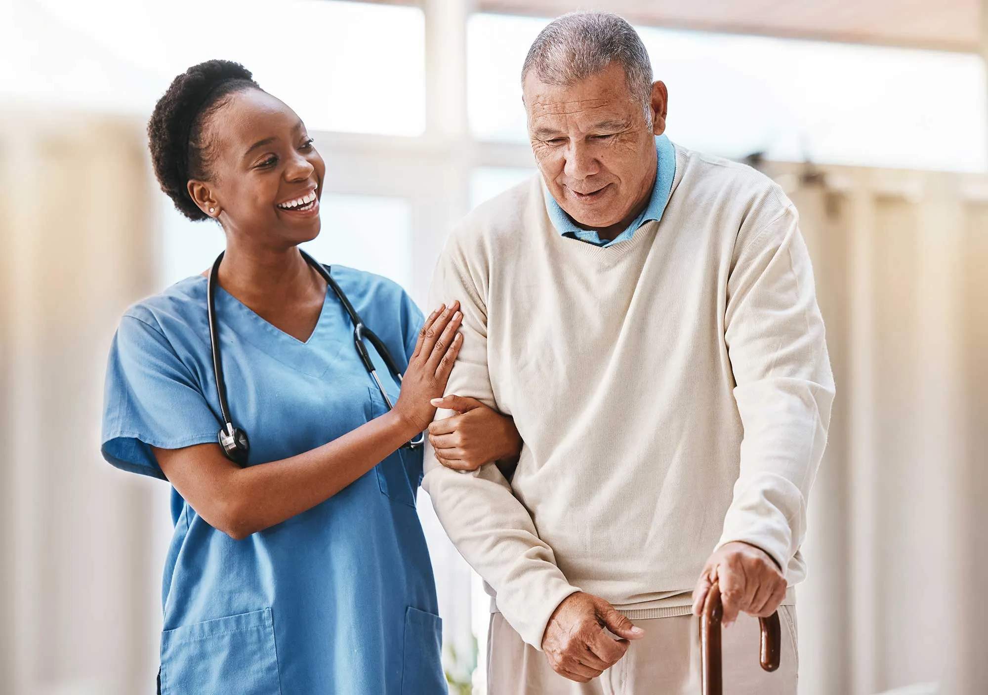 Caregiver helping elderly lady at home