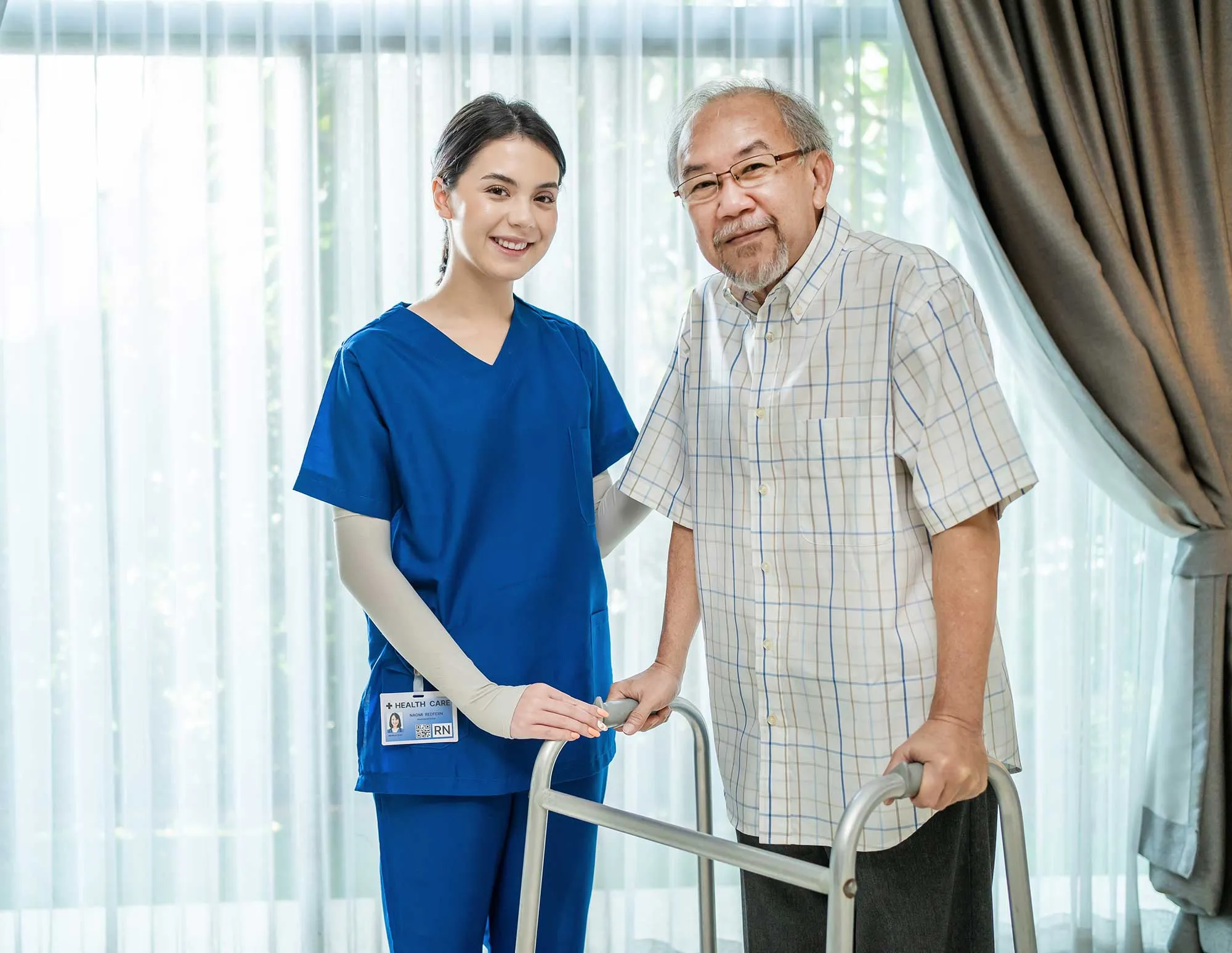 Nurse helping elderly patient walk with walker